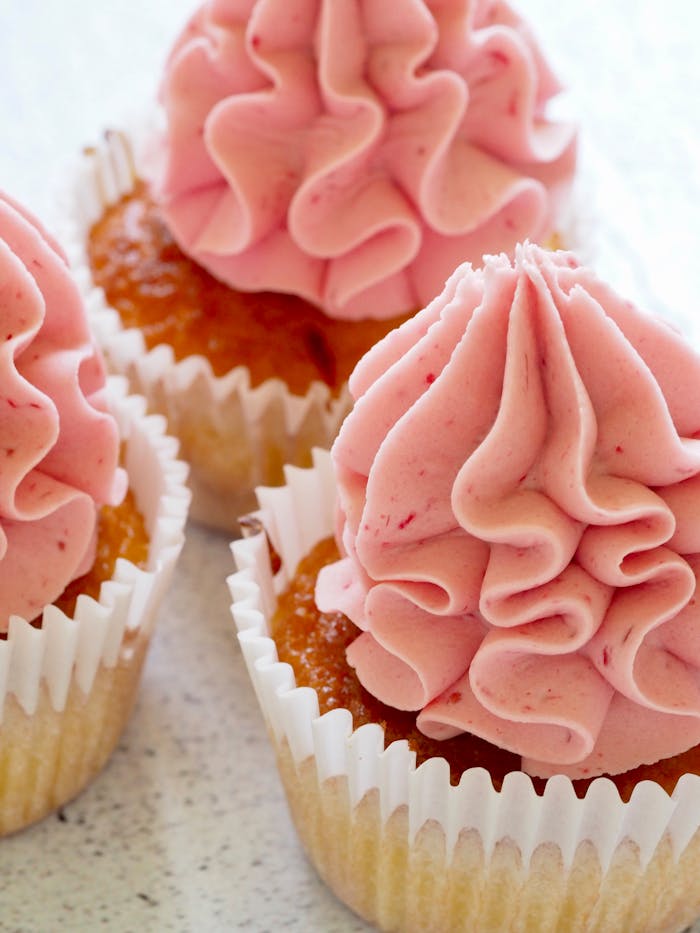 gallery-1 Tasty cupcakes with pink frosting, perfect for a sweet treat or dessert celebration.